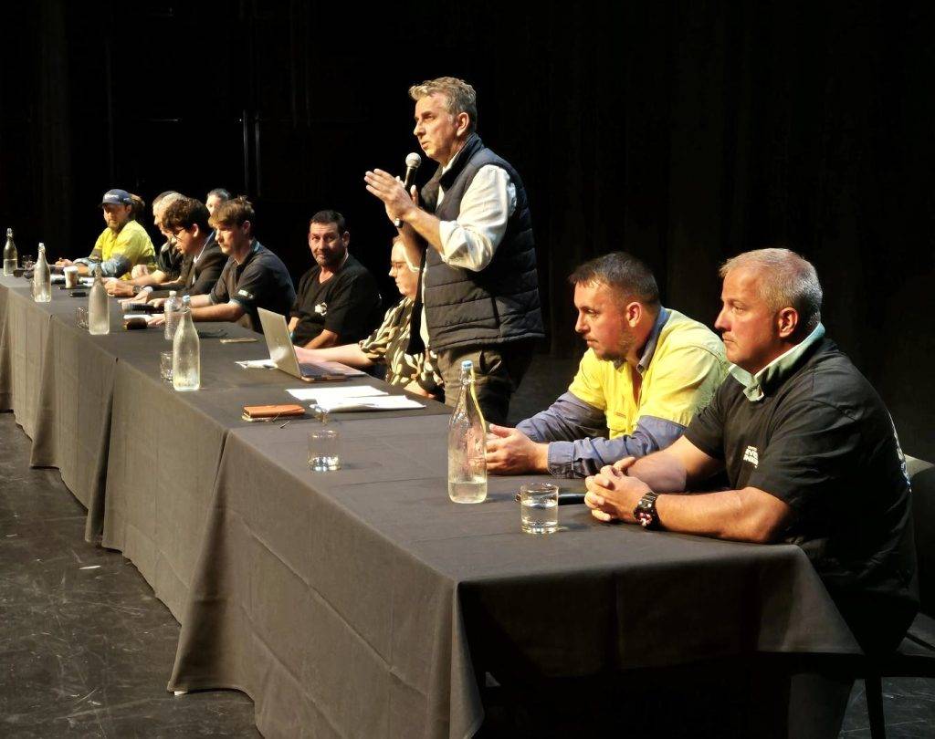 After weeks of frequent meetings with Shoalhaven City Council’s Executive team, including CEO Andrew Constance (pictured standing & addressing members), we arranged a paid mass member meeting and requested Mr Constance join our panel so that members can raise their concerns and have their questions answered by him directly.